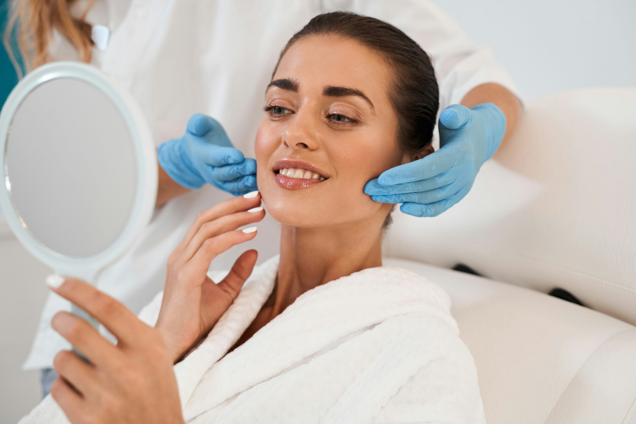 Dr. Beth Collins performing a precise facial assessment to determine the best injection placement for natural results.