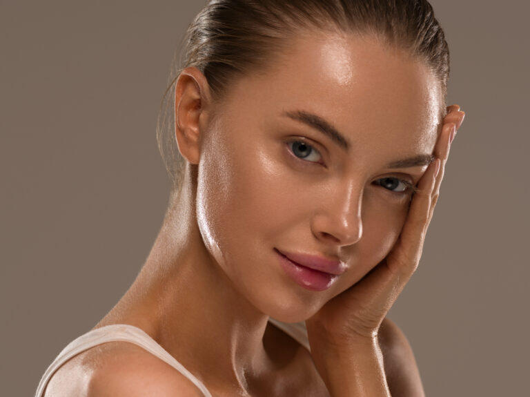 A patient smiling with radiant, healthy skin, illustrating the long-term glow maintenance achieved through professional post-procedure skincare.
